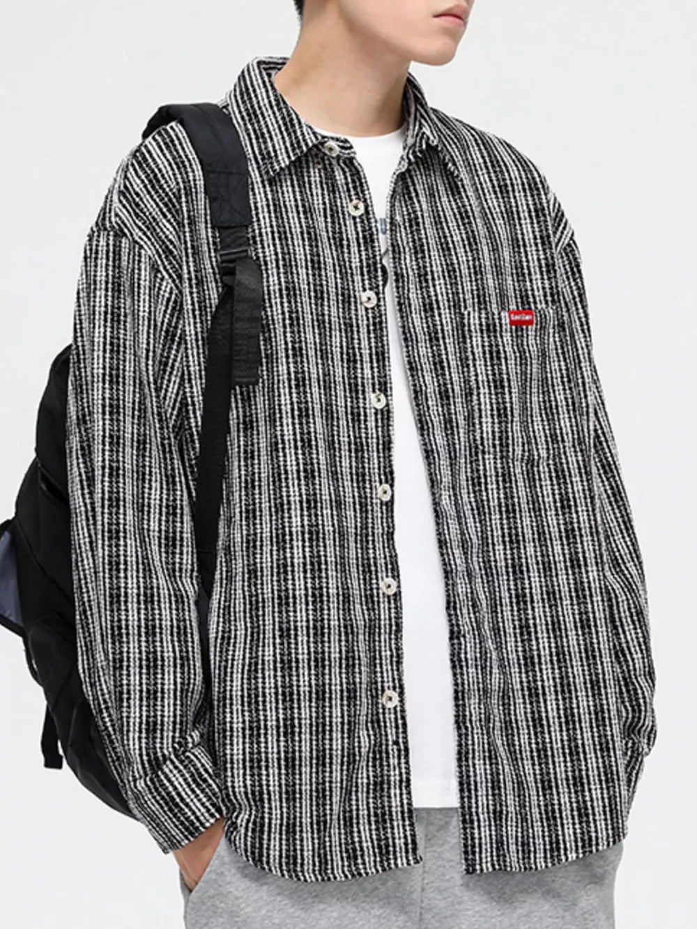 Classic plaid button-up shirt with pocket in black and white, featuring a chest pocket.