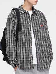 Classic plaid button-up shirt with pocket in black and white, featuring a chest pocket.