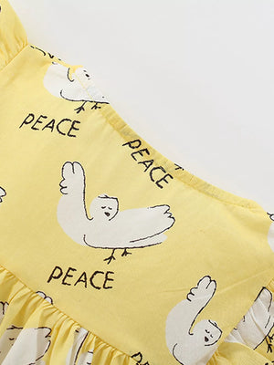 Yellow cotton blend toddler dress with dove print and ruffle sleeves.