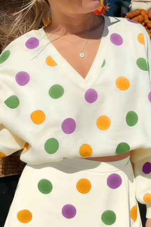 Polka dot V-neck crop top and mini skirt set in cream with purple, green, and orange dots.