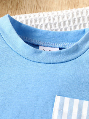 Pastel blue cotton baby tee with striped pocket detail.