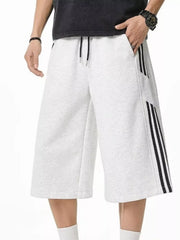 Grey sweatpants with drawstring and black side stripes