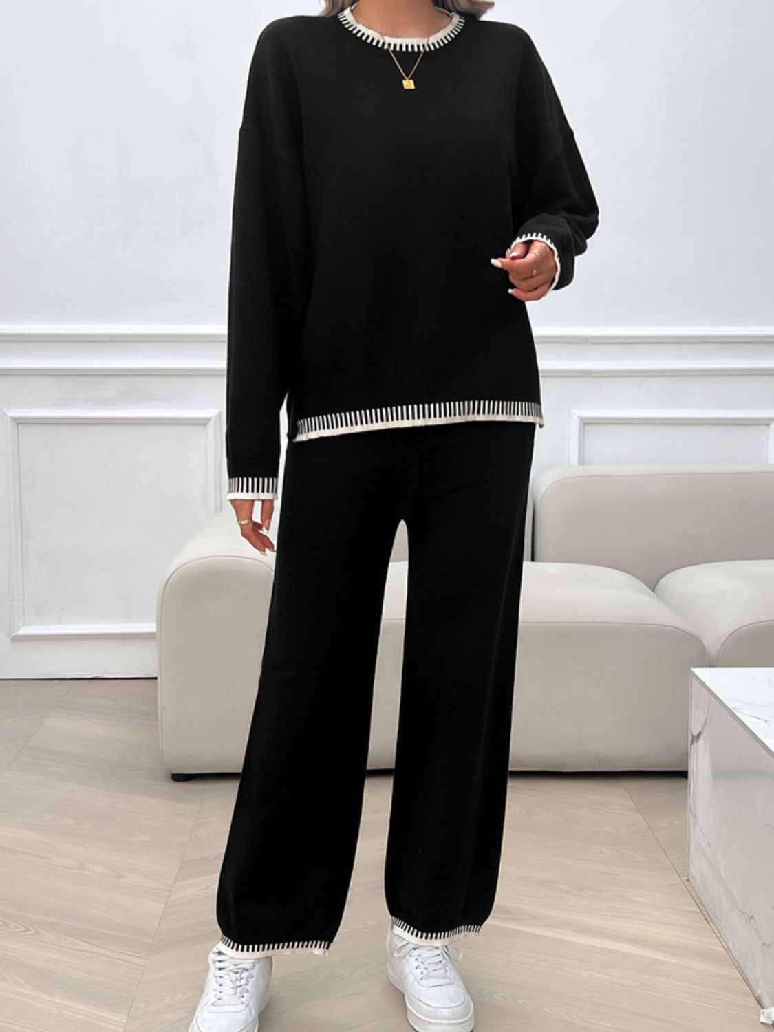 Black knit lounge set with ribbed trim on neckline, cuffs, and hem.