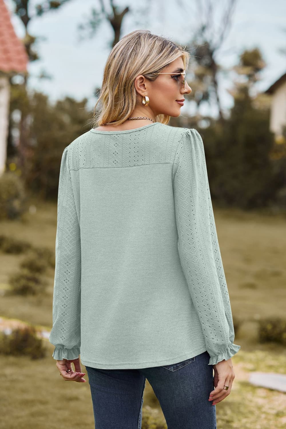 Sage waffle knit blouse with perforated details and ruffled cuffs