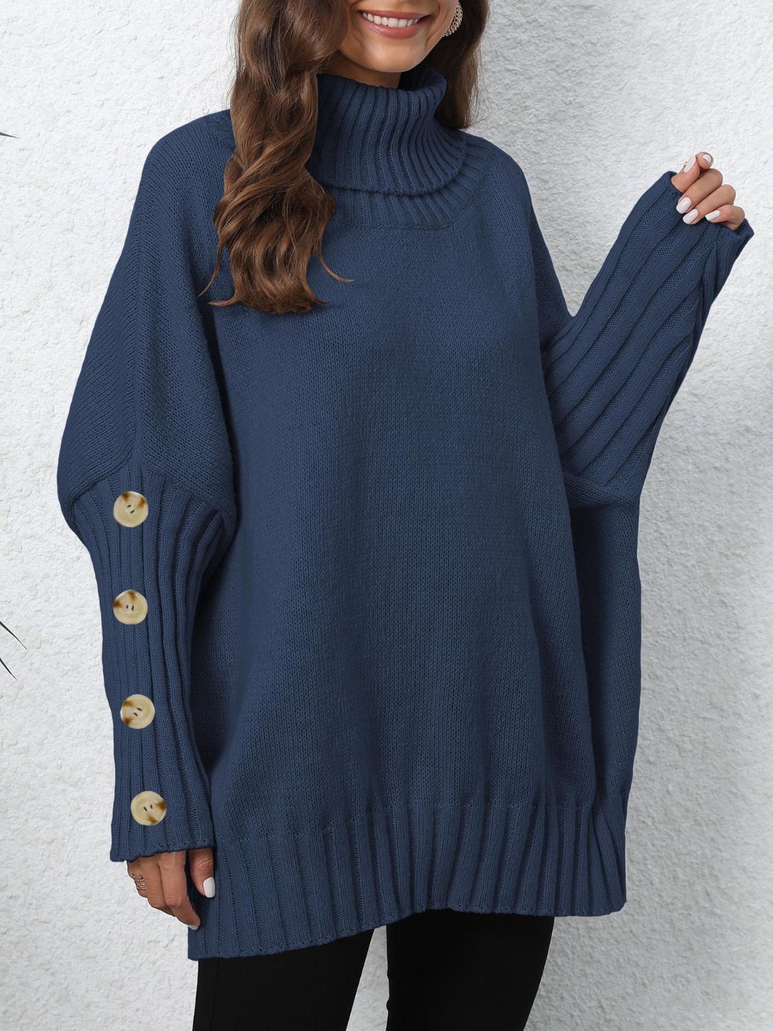 Dark blue turtleneck sweater with button cuff detail and ribbed trim.