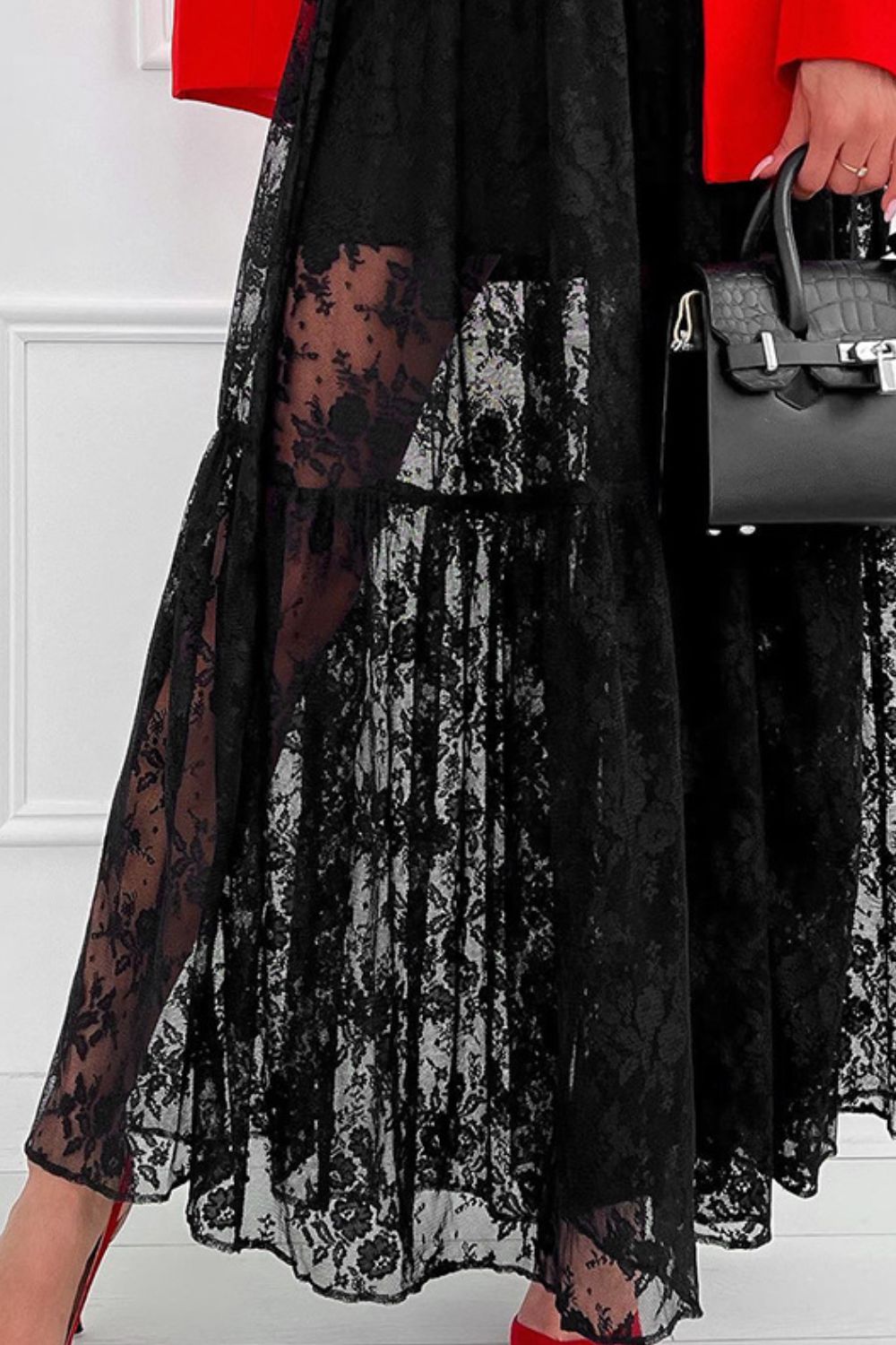 Black floral lace tiered maxi skirt with sheer panels and ruffled hem.