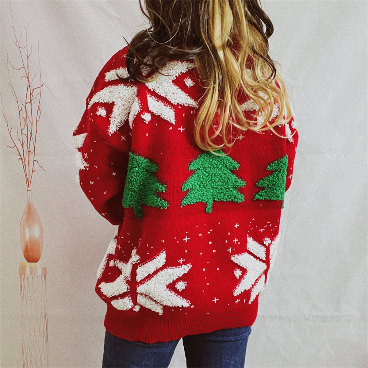 Red acrylic knit sweater with green appliqué Christmas trees and white snowflake details.