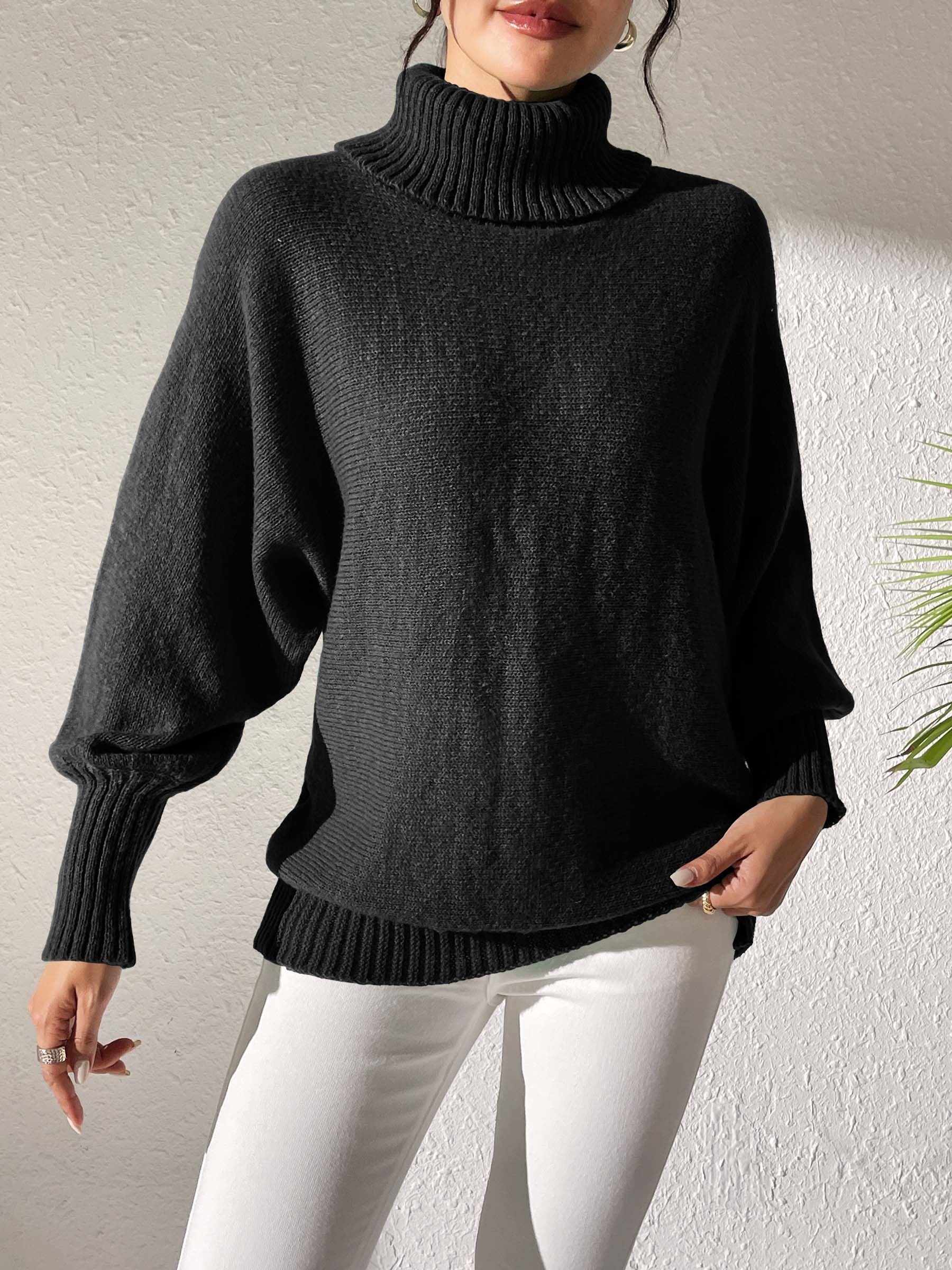 Black balloon sleeve turtleneck sweater with relaxed knit and ribbed cuffs.