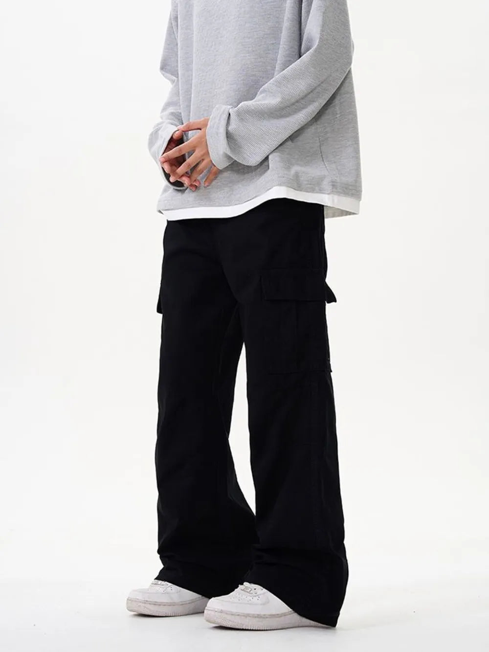 Black cargo pants with versatile pockets and a drawstring waist.