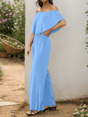 Light blue off-the-shoulder flounce jumpsuit with wide legs and a cinched waist.