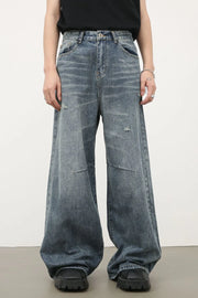 Distressed edge wide-leg jeans in medium wash denim with a relaxed fit and frayed details.