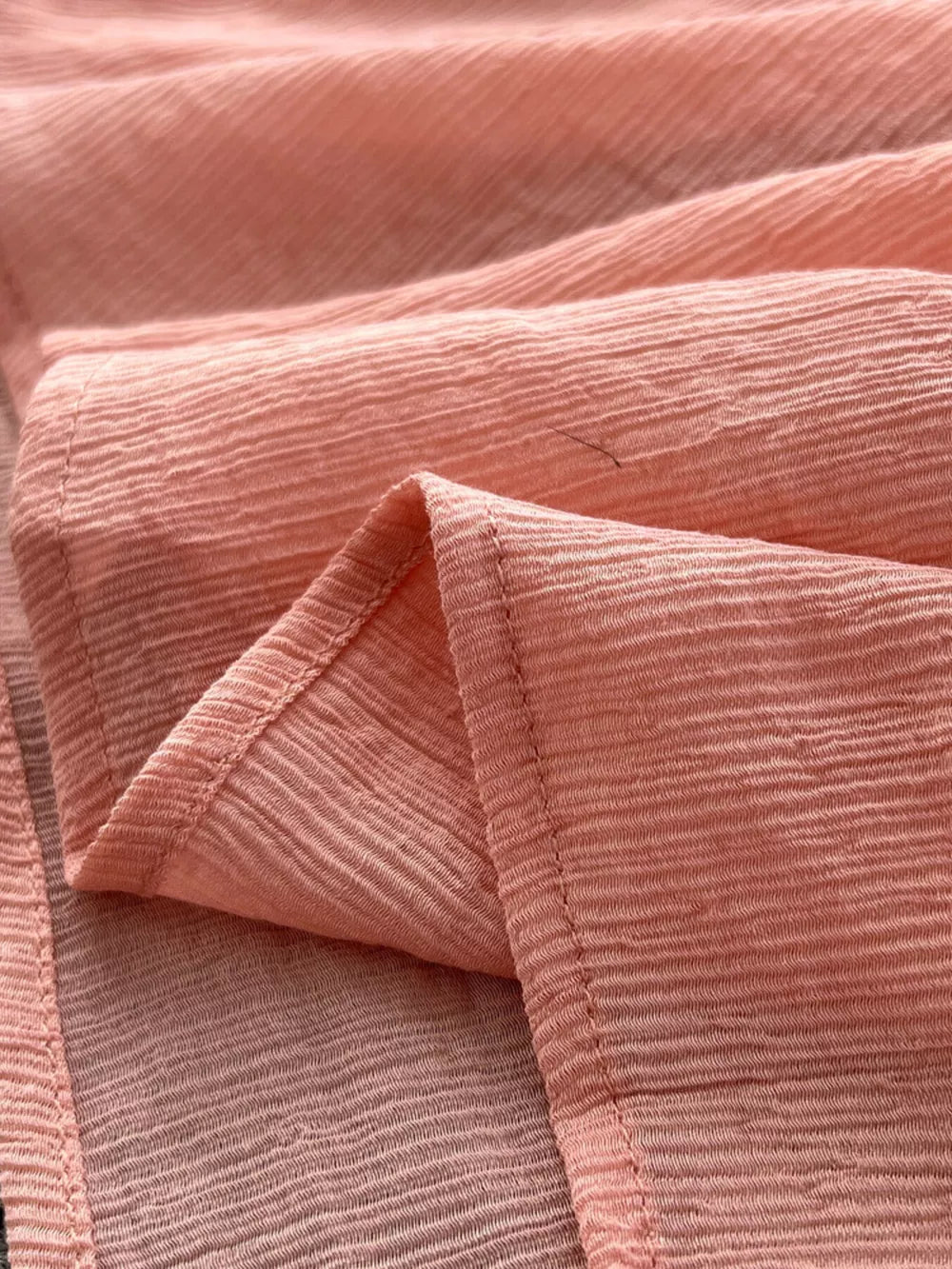 Pink bohemian maxi dress fabric detail with textured crinkle effect.