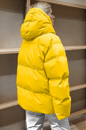 Yellow oversized puffer jacket with hood and quilted detail.