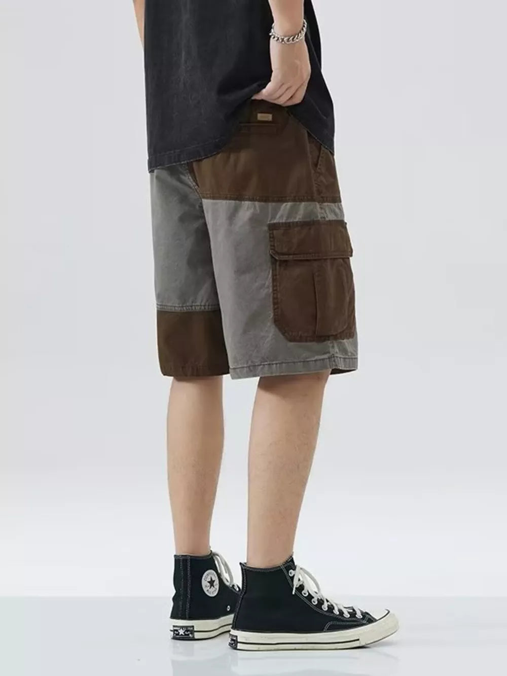 Two-tone cargo shorts with drawstring and multiple pockets in brown and grey color block.