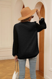 Black Swiss dot blouse with poet sleeves and lace trim cuffs.