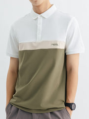 Men's color block polo shirt with white, beige, and olive green panels and a subtle "POSITIVE" graphic.