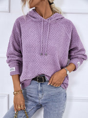 Lavender textured knit raglan sleeve hoodie with drawstring hood and cuff detail.