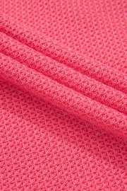 Blush pink waffle knit fabric detail of a shacket with pockets.