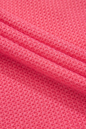 Blush pink waffle knit fabric detail of a shacket with pockets.