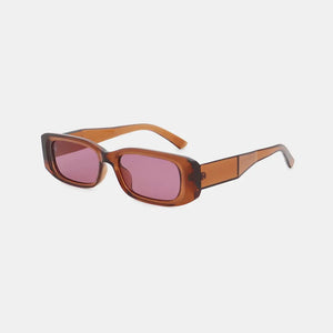 Chunky rectangular sunglasses in caramel with pink lenses and thick frames.