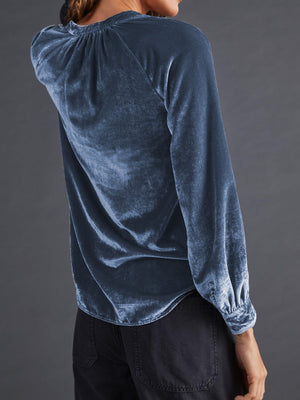 Dusty blue velvet blouse with gathered yoke and buttoned cuffs.
