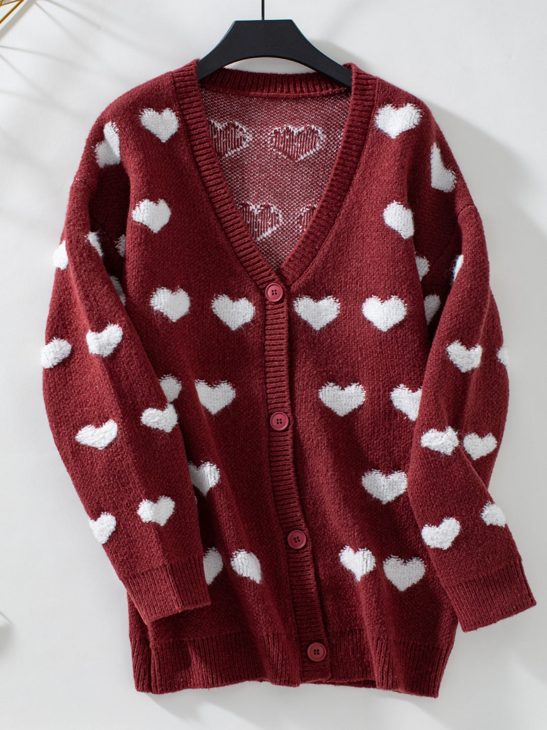 Burgundy acrylic button-front cardigan with white heart pattern