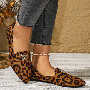 Point toe slip-on flats with leopard print and cheetah head embellishment.