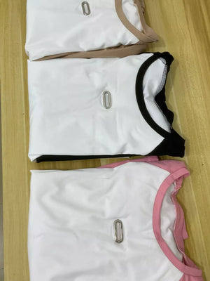 Chic contrast two-piece tee and pants set in camel, black, and pink with metal detail.