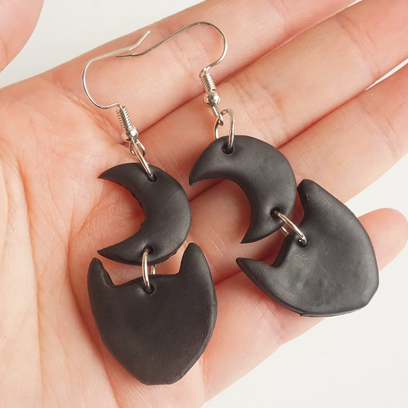 Black Halloween charm drop earrings with moon and cat shapes.