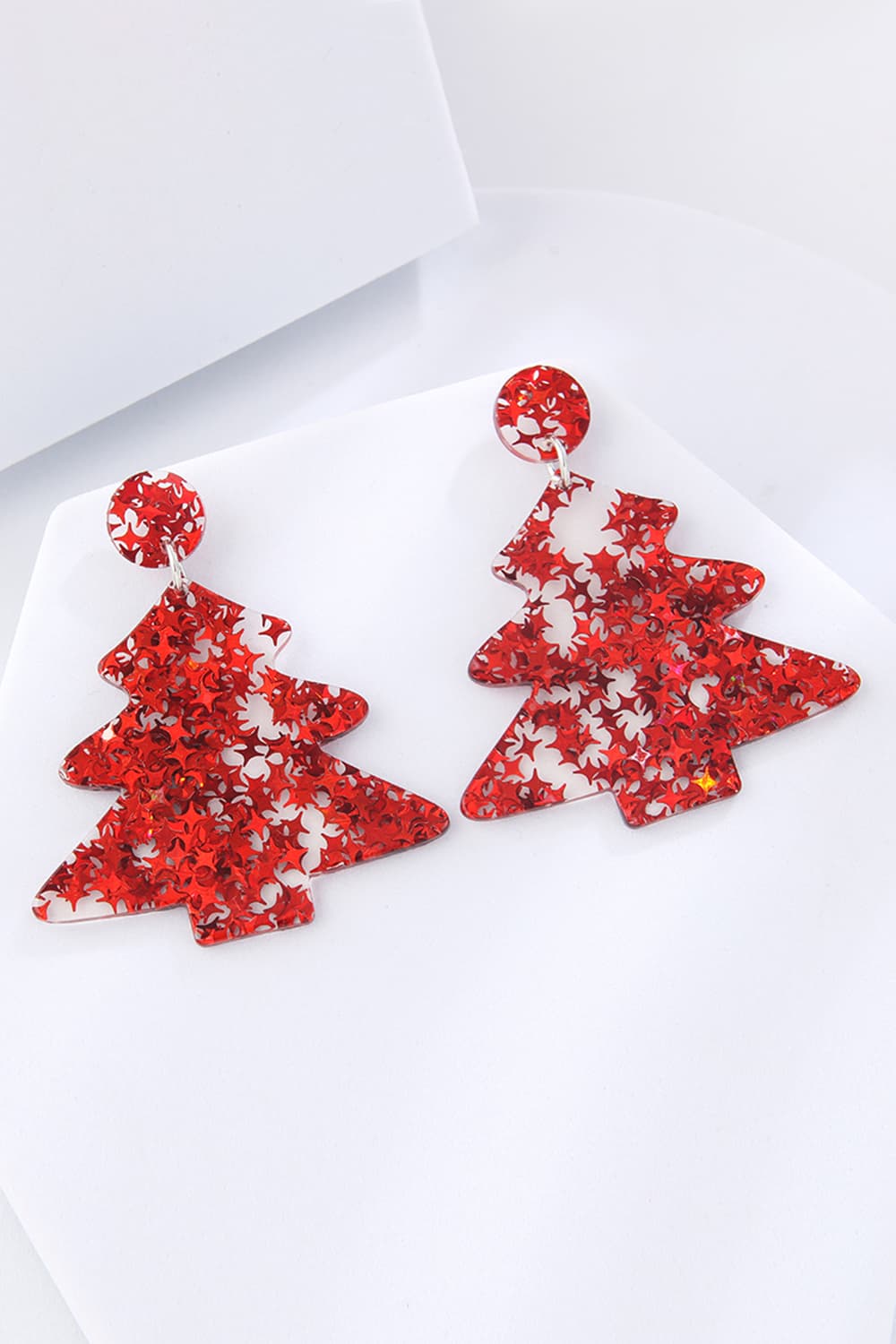 Red acrylic Christmas tree drop earrings with star glitter detail