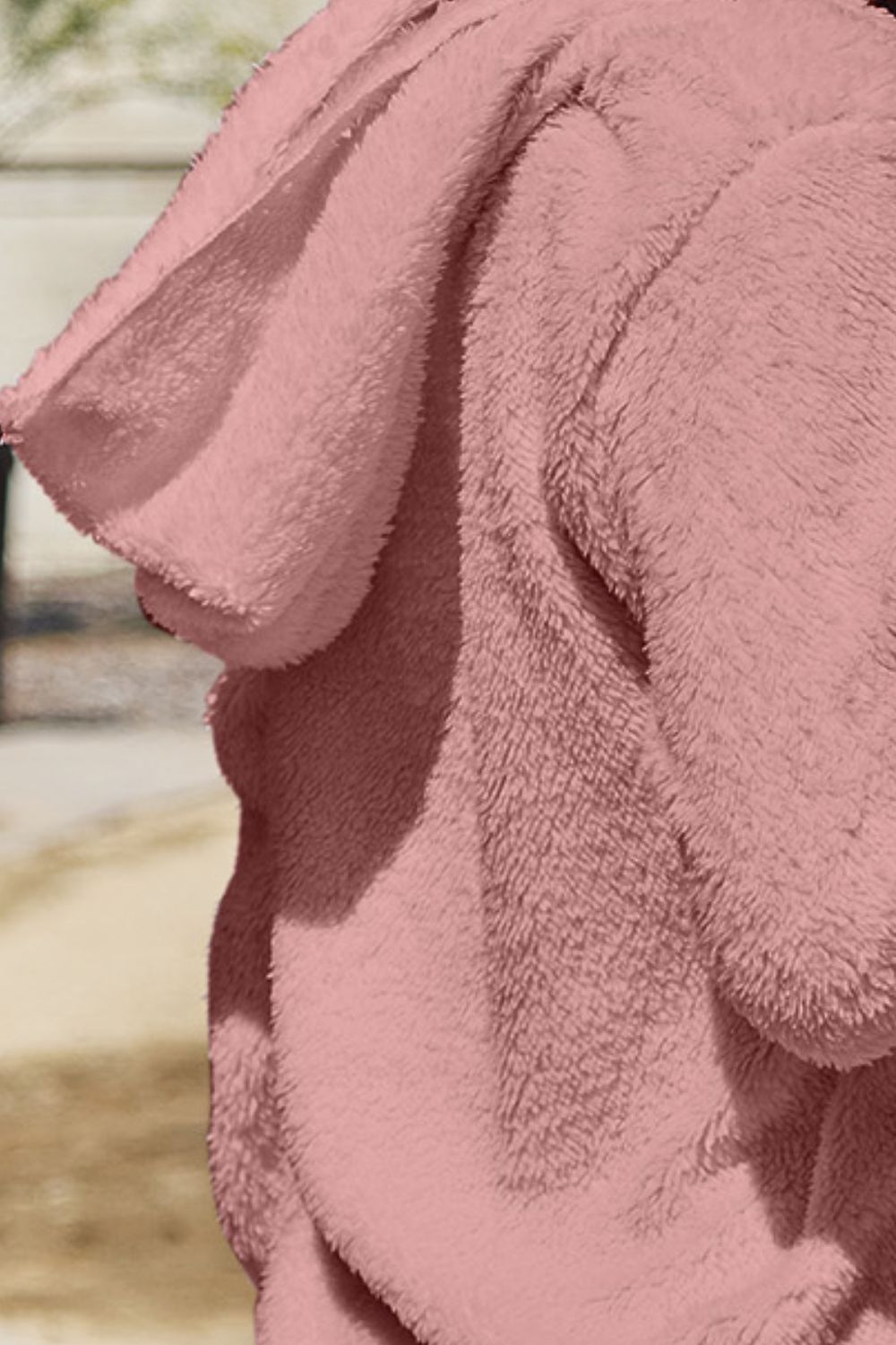 Plush hooded cardigan jacket in blush pink with a soft, fuzzy texture.