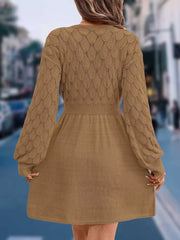 Tan openwork knit V-neck sweater dress with cinched waist and above-knee length.