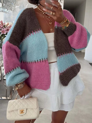 Pastel color block open front cardigan with balloon sleeves, worn with a white top and skirt.