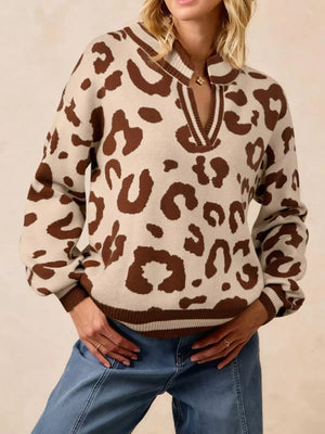 Chic leopard print knit sweater with notched neckline and striped trim.