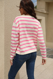 Pink and white striped crewneck cardigan with long sleeves.