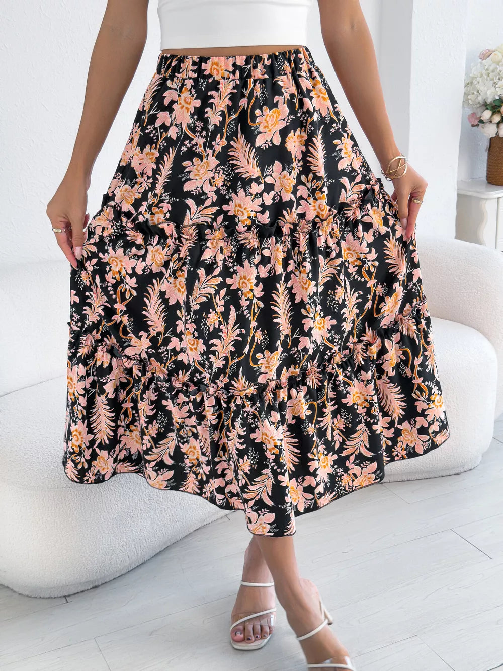 Midi skirt with floral print, ruffle hem, and tiered design.