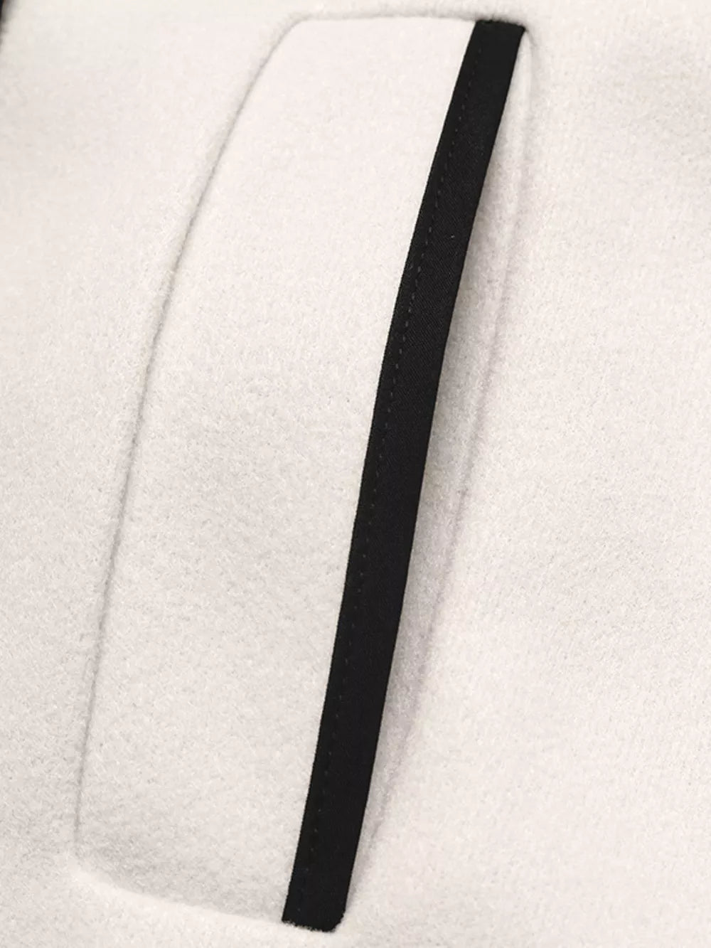 Beige bolero jacket with black contrast trim detail on pocket