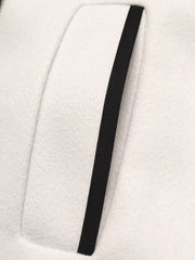 Beige bolero jacket with black contrast trim detail on pocket