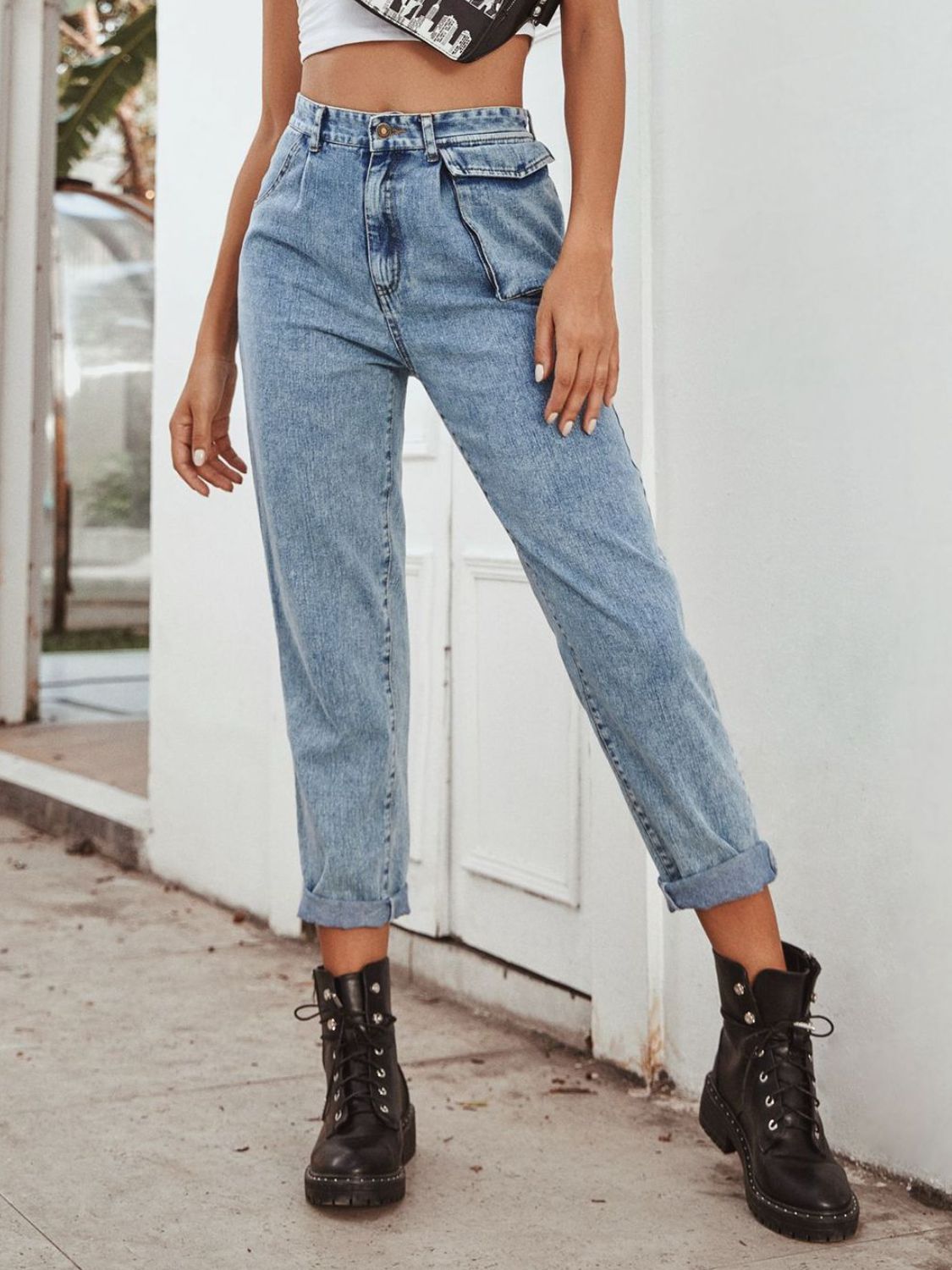 Light wash cotton barrel leg jeans with unique pocket details and cuffed hems.