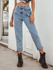 Light wash cotton barrel leg jeans with unique pocket details and cuffed hems.
