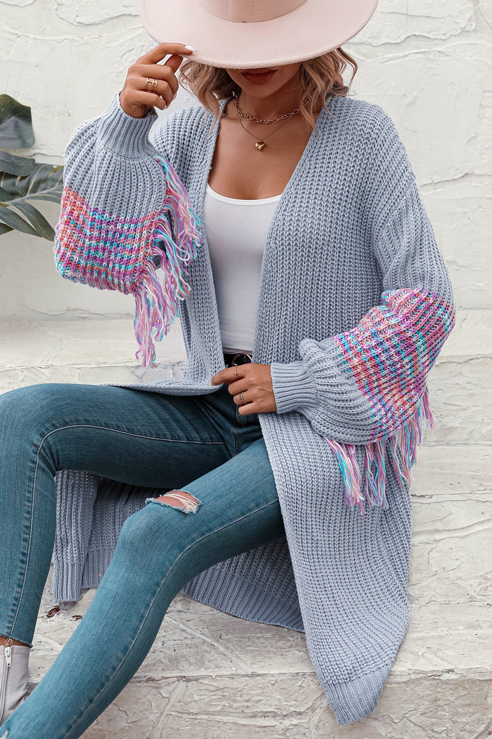 Cloudy Blue acrylic cardigan with textured sleeves and colorful fringe detail.