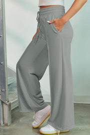 Heather gray palazzo joggers with drawstring waist and center seam detail.