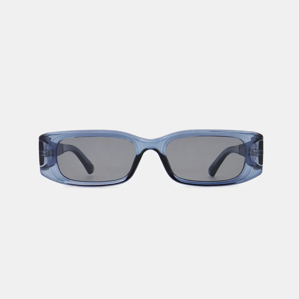 Chunky rectangular sunglasses in dusty blue with dark lenses and thick frames.