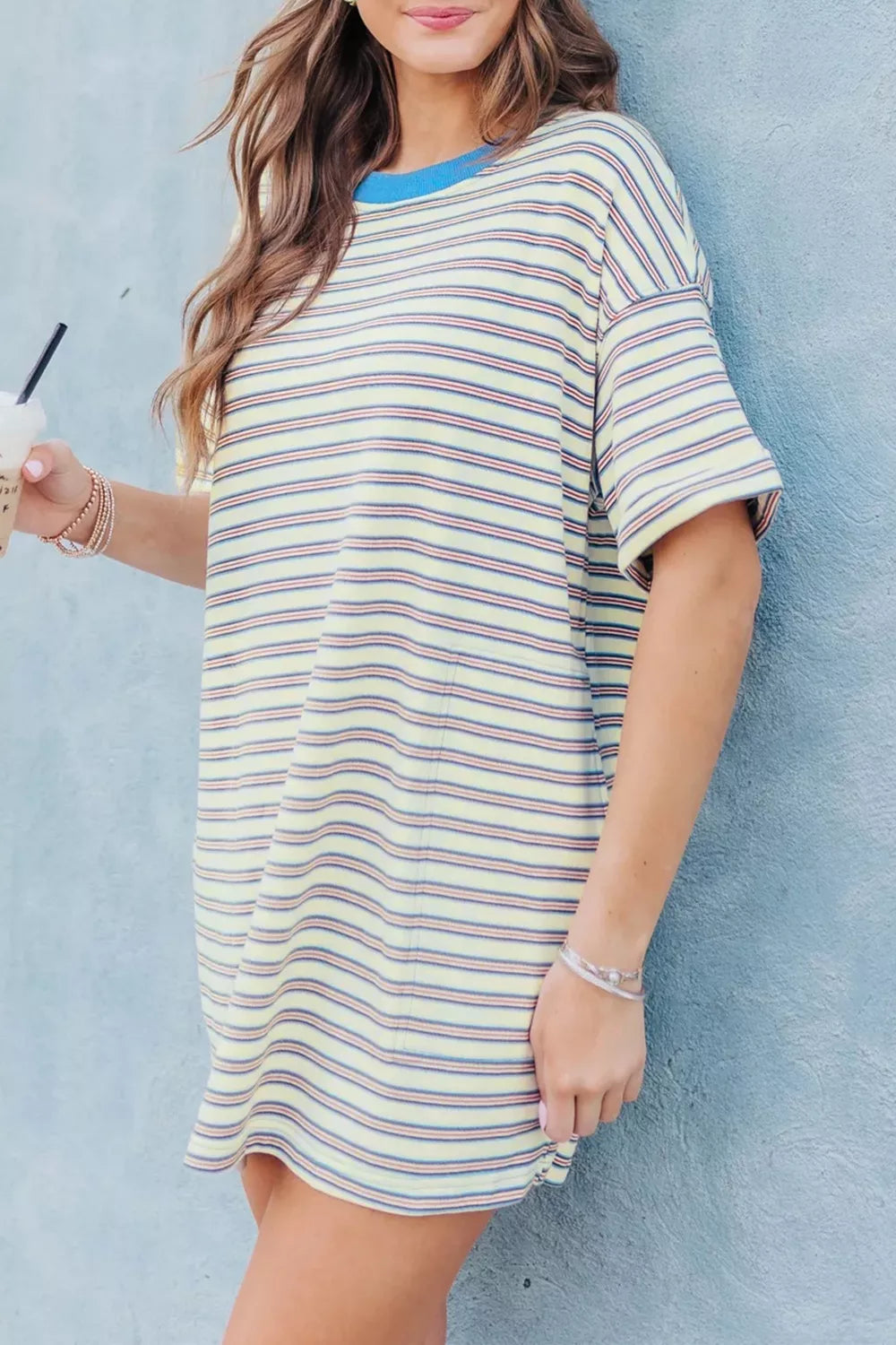 Casual striped mini dress with pockets in yellow, red, and blue stripes.