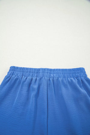 Blue drawstring shorts with elastic waistband and textured fabric detail.