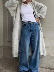 Light gray plush maxi cardigan with balloon sleeves worn open over a white top and jeans.
