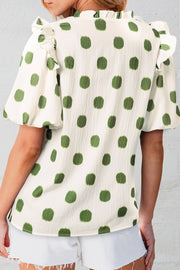 Textured polka dot blouse in matcha green with ruffled neckline and sleeves.