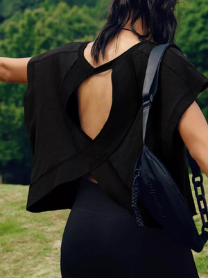 Black t-shirt with cutout back detail and crisscross straps.