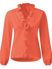 Pumpkin blouse with cascading ruffle front and balloon sleeves.