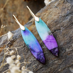 Verdant Stone Teardrop Dangle Earrings in blue/purple/gold feature marbled purple and teal stones with gold hooks.